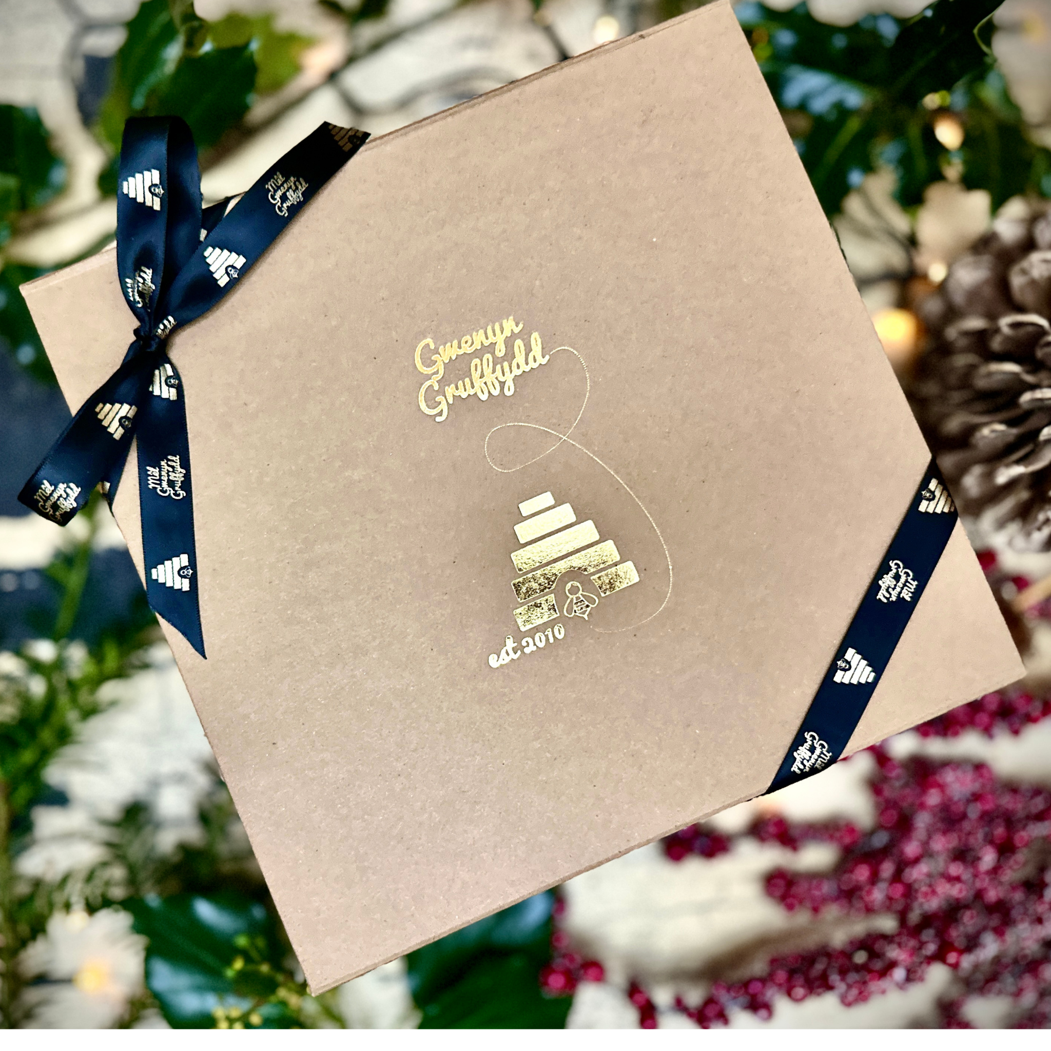 Gwenyn Gruffydd Christmas Shop featuring luxury beekeeping gift sets, pure beeswax candles, Welsh honey hampers, and festive gifts for beekeepers.
