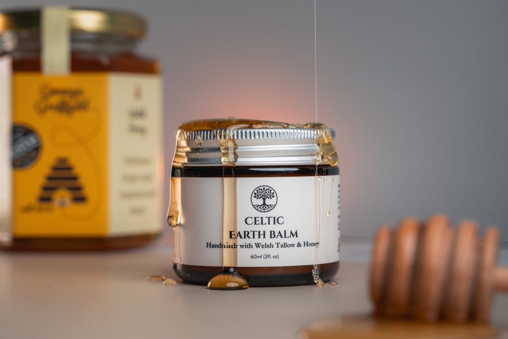Jar of Celtic Earth Tallow Balm on a table with a blurred background
