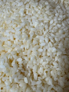 Light yellow cosmetic grade beeswax pellets for skincare and candle making